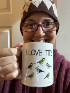 picture of TB holding an I Love Tits mug