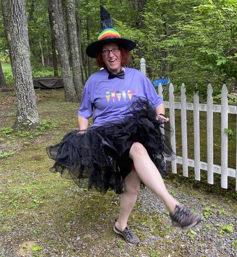 Miranda kicking up her feet in witch pride outfit